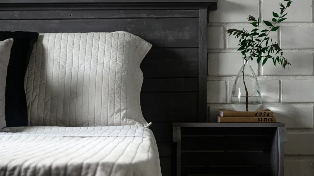 Professional bedroom furniture layout rules showing a bed centered on a solid wall with symmetrical nightstands.