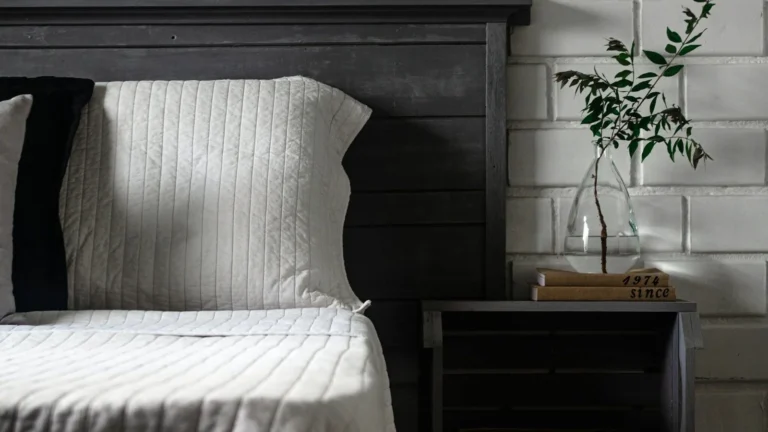 Professional bedroom furniture layout rules showing a bed centered on a solid wall with symmetrical nightstands.