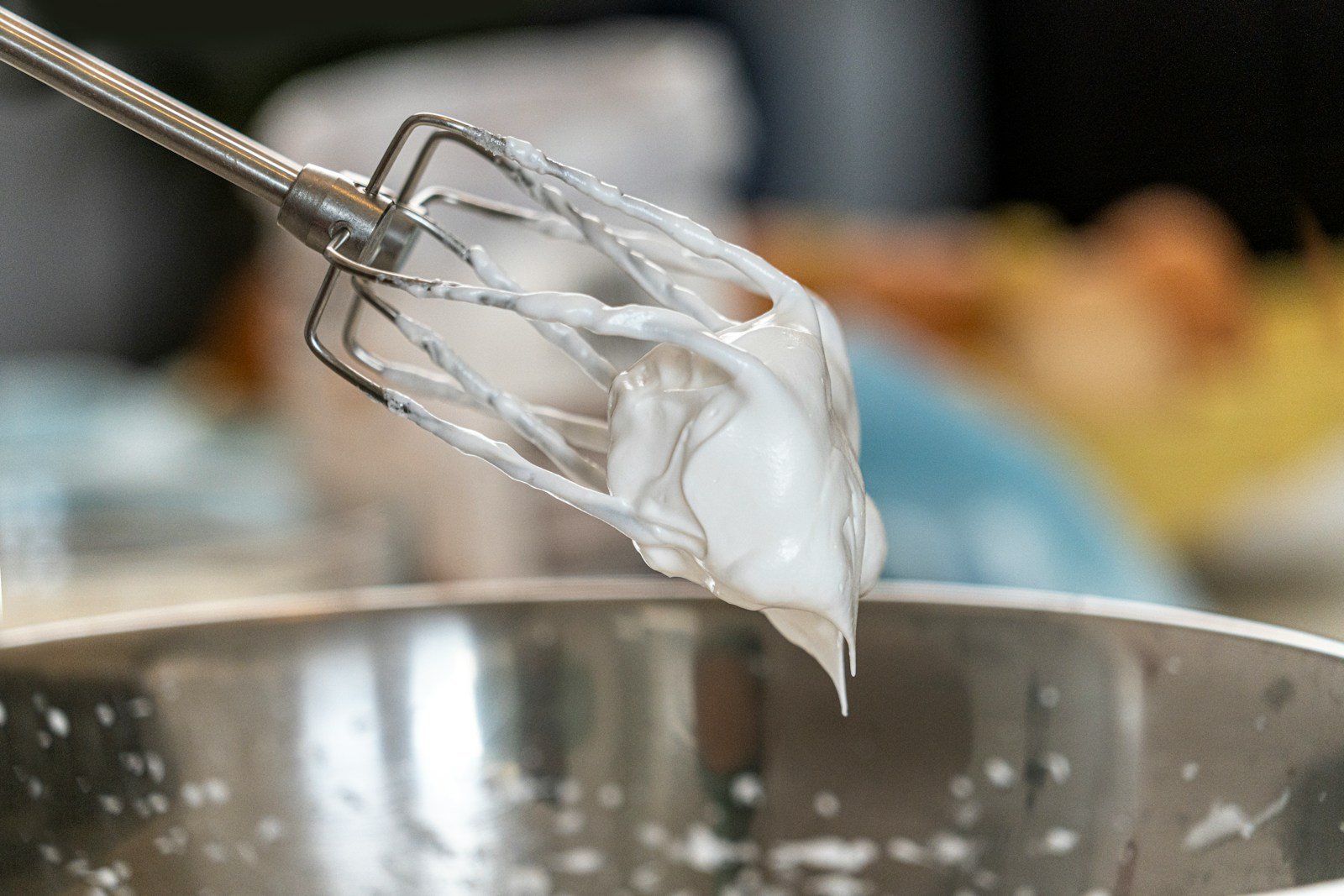 Whipping heavy cream into stiff peaks for a no-churn dessert.